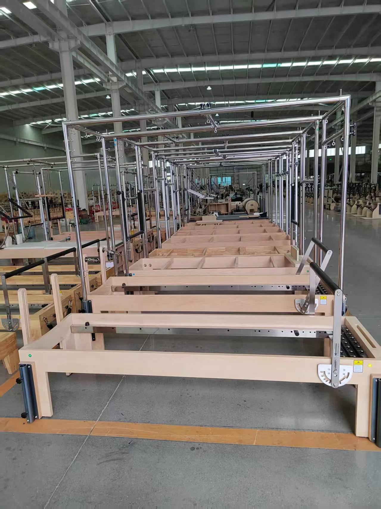 Rows of Lumina Pilates reformers prepared for factory inspection