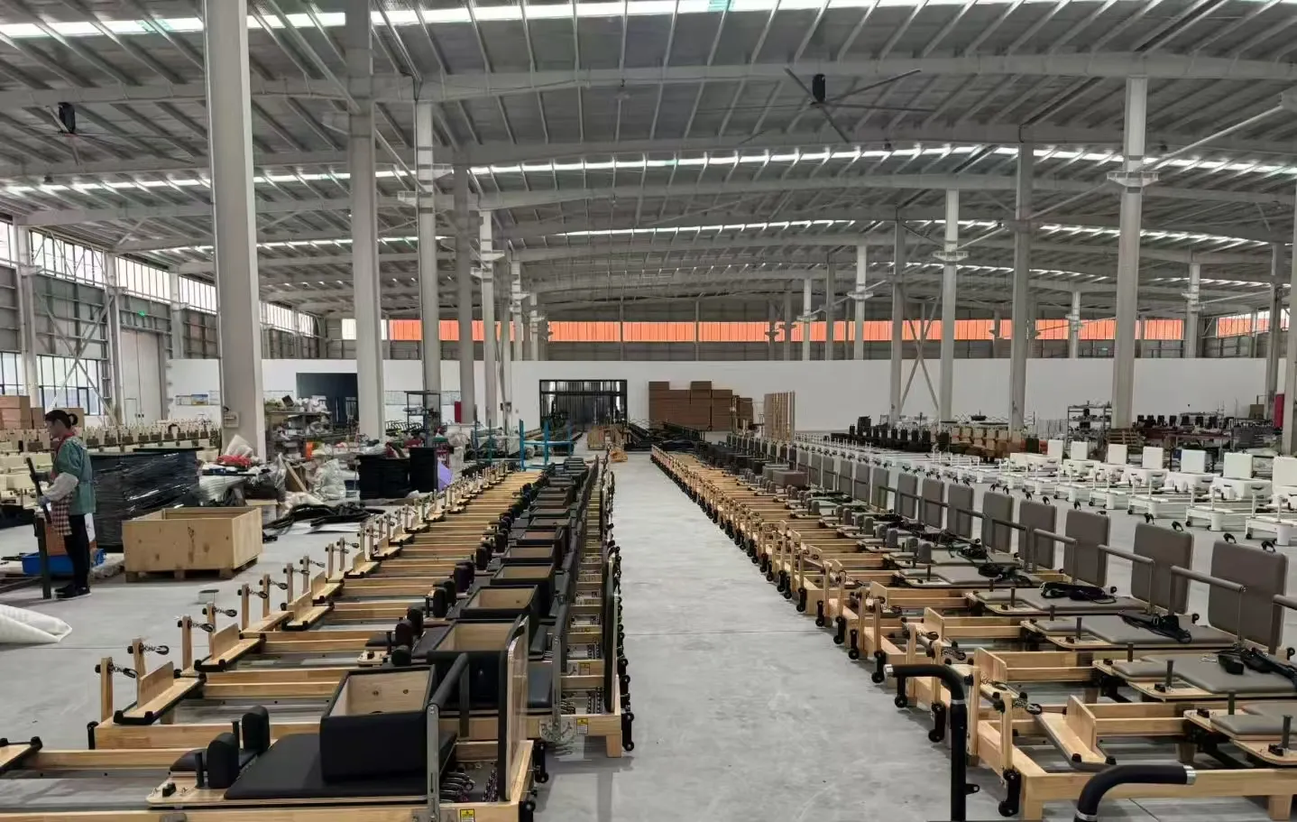 Wide Lumina factory view with wooden Pilates reformers in production