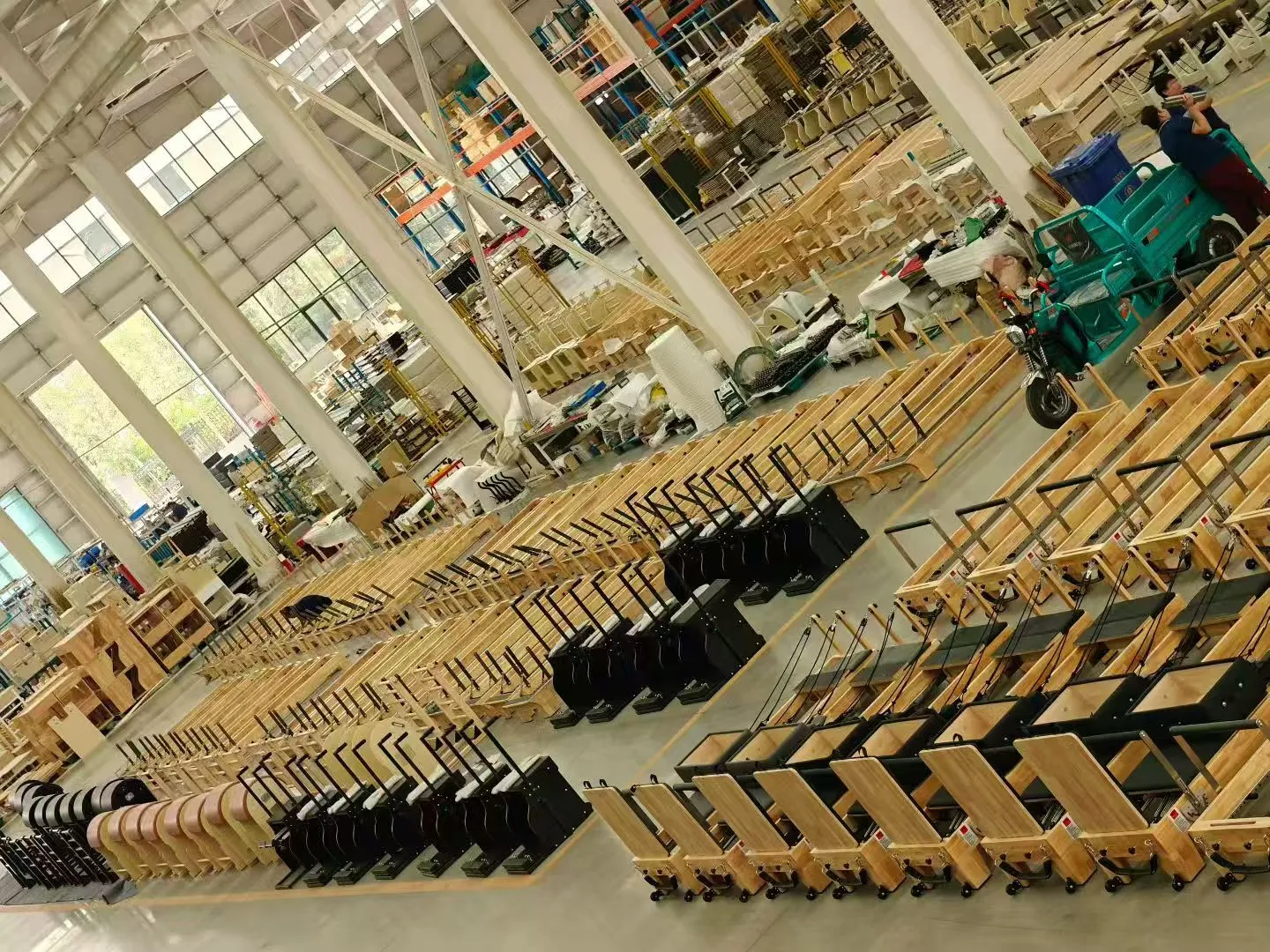 Wood Pilates equipment frames arranged in the production workshop